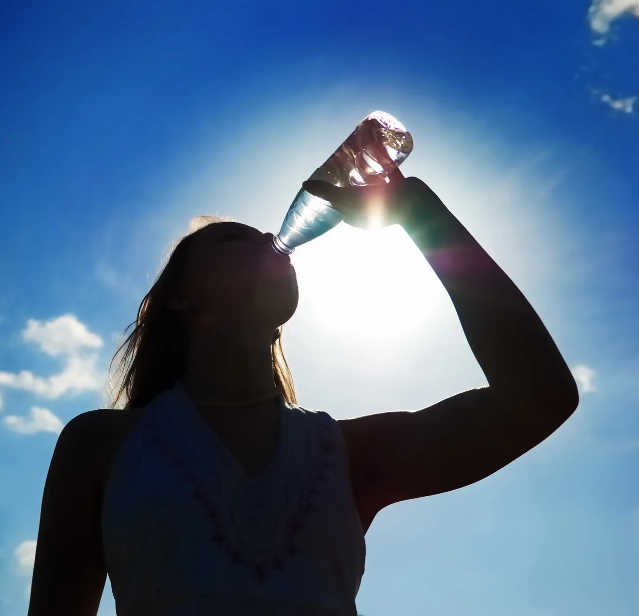 woman drinking water in the sun